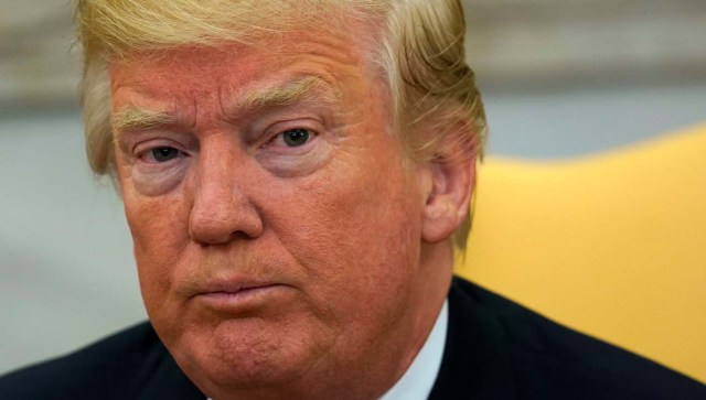 U.S. President Donald Trump looks up as reporters ask questions about the future of U.S. Secretary of State Rex Tillerson in the Oval Office at the White House in Washington, U.S., November 30, 2017. REUTERS/Kevin Lamarque