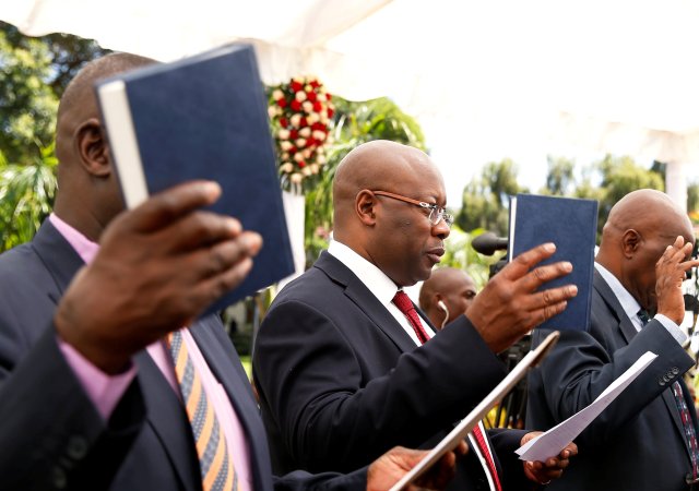 Zimbabwe's Minister of Mines and Mining Development Winston Chitando takes an oath of office with other ministers during a swearing in ceremony at State House in Harare, Zimbabwe December 4, 2017. REUTERS/Philimon Bulawayo