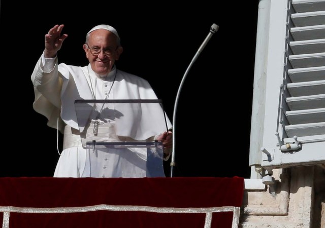 Pope Francis waves during his Sunday Angelus prayer, on the day of his birthday, in Saint Peter's square at the Vatican December 17, 2017. REUTERS/Tony Gentile