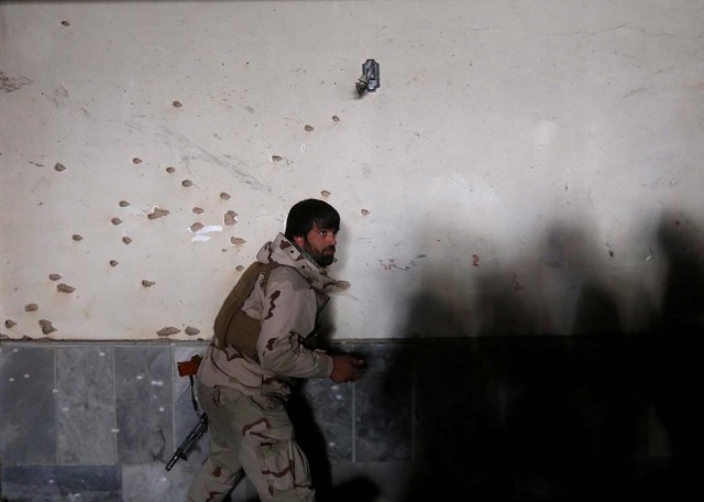An Afghan security force inspects bullet holes at the site of a suicide attack in Kabul, Afghanistan December 28, 2017. REUTERS/Omar Sobhani