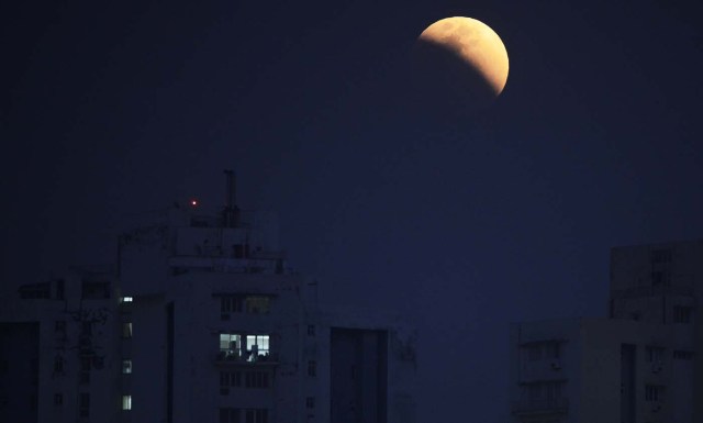 The moon is seen during a lunar eclipse referred to as the "super blue blood moon", in Kolkata on January 31, 2018. Skywatchers were hoping for a rare lunar eclipse that combines three unusual events -- a blue moon, a super moon and a total eclipse -- which was to make for a large crimson moon viewable in many corners of the globe / AFP PHOTO / Dibyangshu SARKAR