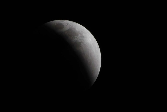 The moon is seen during a lunar eclipse, referred to as the "super blue blood moon", in Beijing on January 31, 2018. Skywatchers were hoping for a rare lunar eclipse that combines three unusual events -- a blue moon, a super moon and a total eclipse -- which was to make for a large crimson moon viewable in many corners of the globe. / AFP PHOTO / NICOLAS ASFOURI