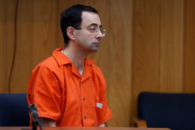 Larry Nassar, a former team USA Gymnastics doctor who pleaded guilty in November 2017 to sexual assault charges, listens to Judge Janice Cunningham during his sentencing hearing in the Eaton County Court in Charlotte, Michigan, U.S., February 5, 2018. REUTERS/Rebecca Cook