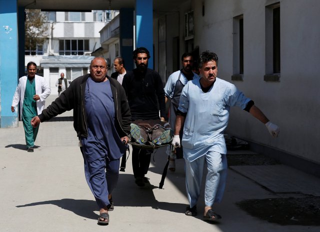 Men carry a victim on a stretcher at a hospital after a blast in Kabul, Afghanistan March 21, 2018. REUTERS/Mohammad Ismail