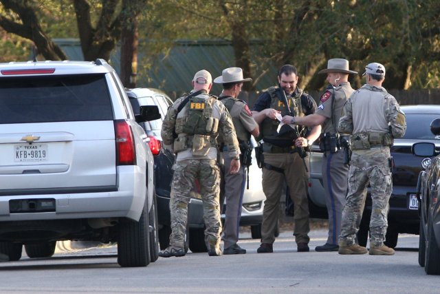 Law enforcement personnel investigate the surroundings of a house linked to the bomber in Pflugerville, Texas, U.S., March 21, 2018. REUTERS/Loren Elliott