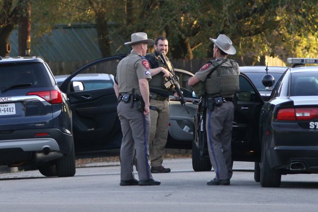 Law enforcement personnel investigate the surroundings of a house linked to the bomber in Pflugerville, Texas, U.S., March 21, 2018. REUTERS/Loren Elliott