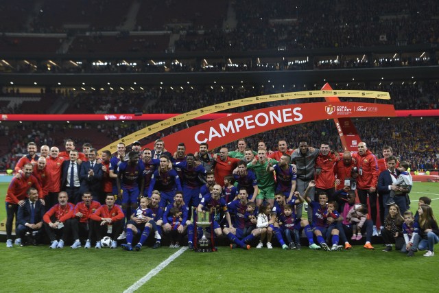 Barcelona's players pose with the trophy after winning the Spanish Copa del Rey (King's Cup) final football match Sevilla FC against FC Barcelona at the Wanda Metropolitano stadium in Madrid on April 21, 2018.  Barcelona won 5-0.  / AFP PHOTO / LLUIS GENE