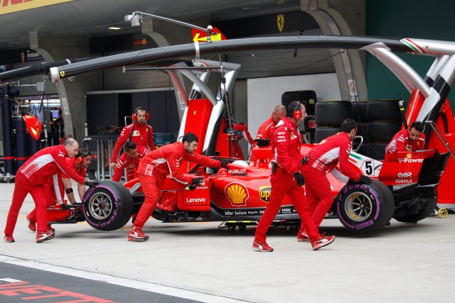 Formula One - F1 - Chinese Grand Prix - Shanghai, China - April 14, 2018 - The car of Ferrari driver Sebastian Vettel is pushed back to the team's garage during the qualifying session. Pool via REUTERS