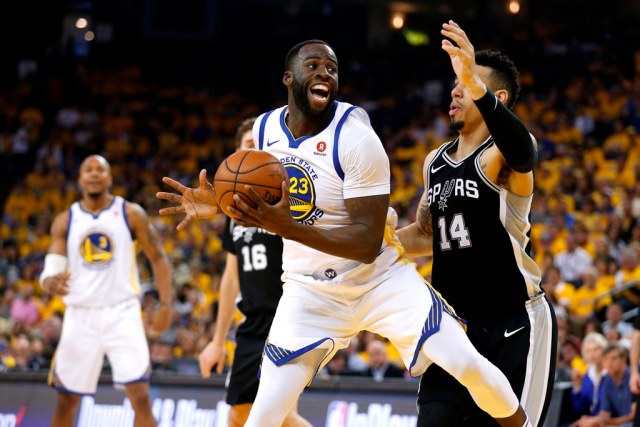 Apr 14, 2018; Oakland, CA, USA; Golden State Warriors forward Draymond Green (23) spins towards the hoop next to San Antonio Spurs guard Danny Green (14) in the second quarter in game one of the first round of the 2018 NBA Playoffs at Oracle Arena. Mandatory Credit: Cary Edmondson-USA TODAY Sports