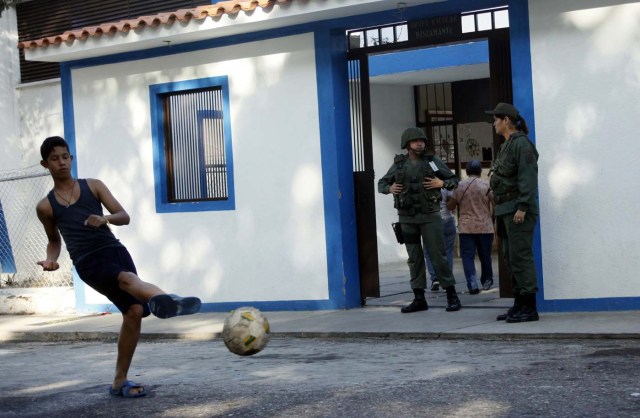 A youth kicks a ball in front of a polling station during the presidential election in San Cristobal, Venezuela, May 20, 2018. REUTERS/Carlos Eduardo Ramirez