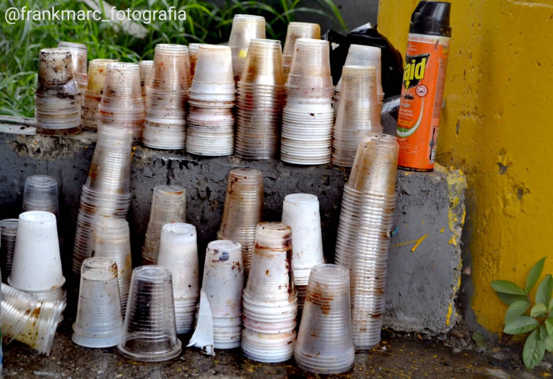 Este hombre, en situación de calle, lava vasos plásticos con vinagre y agua del Guaire para revenderlos (FOTOS)