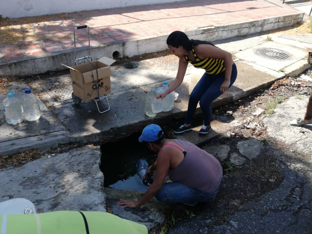 Vecinos de Palo Verde recogen agua estancada en un pozo en plena calle (FOTOS + VIDEOS)